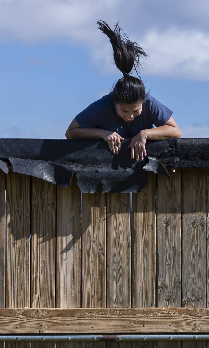 Attendee Melanie Aquino battles to get over a wooden wall as women participate in an outside ci ...