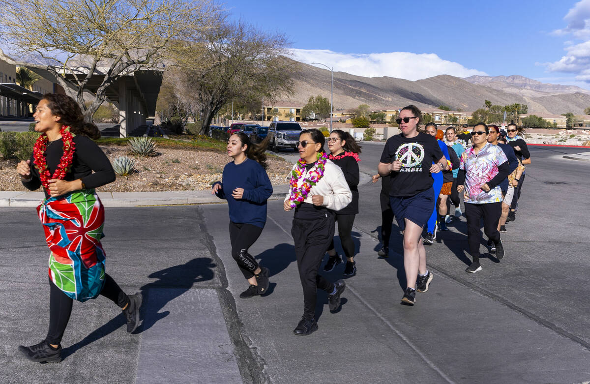 Attendees take a short warm up run before working out and learning defensive tactics with the M ...