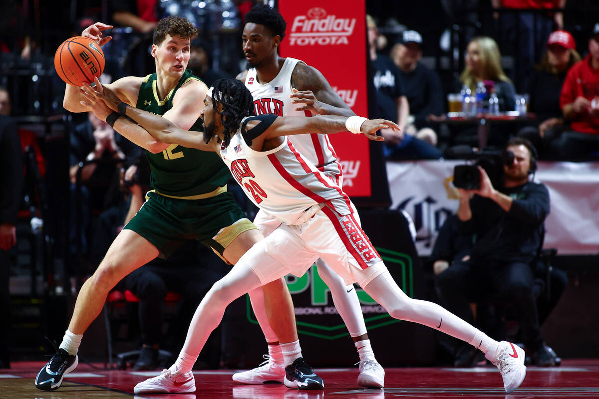 UNLV Rebels forward Keylan Boone (20) and Kalib Boone (10) defend against Colorado State Rams f ...