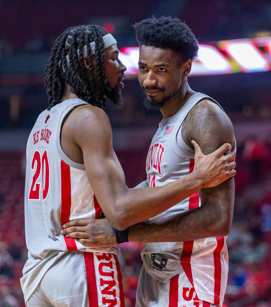 UNLV forward Keylan Boone (20) and his brother UNLV forward Kalib Boone (10) come together to t ...