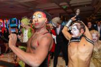 Cirque du Soleil performers walk through the Bellagio as part of the “O” anniversary parade ...