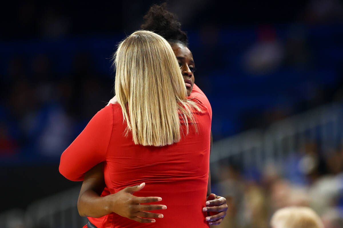 UNLV Lady Rebels head coach Lindy La Rocque hugs center Desi-Rae Young as she leaves the court ...