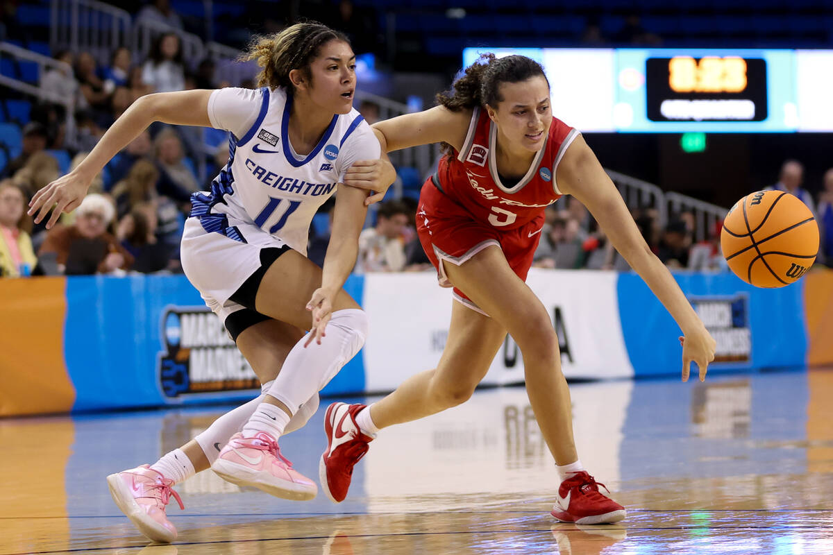 UNLV Lady Rebels guard Kiara Jackson (3) and Creighton Bluejays guard Kiani Lockett (11) strugg ...