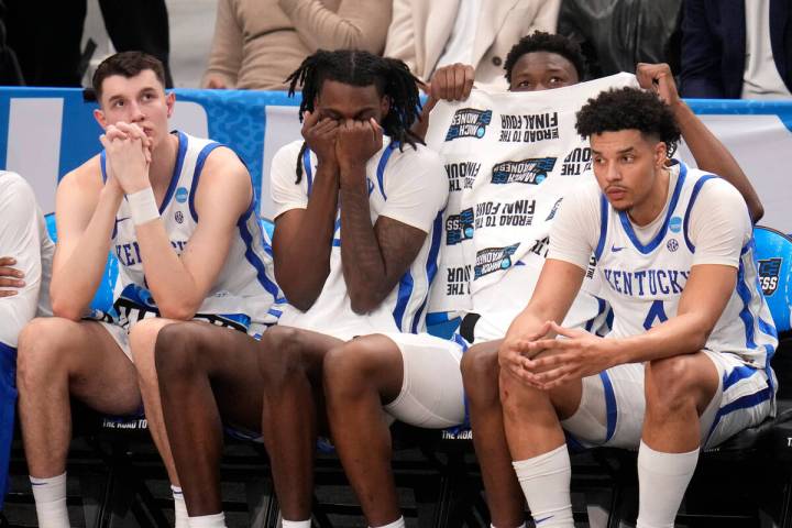 Players on the Kentucky bench watch late in the second half of the team's college basketball ga ...