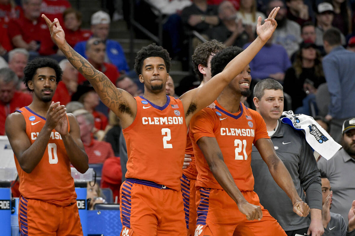 Clemson's Josh Beadle (0), Dillon Hunter (2) and Chauncey Wiggins (21) celebrate the team's 72- ...