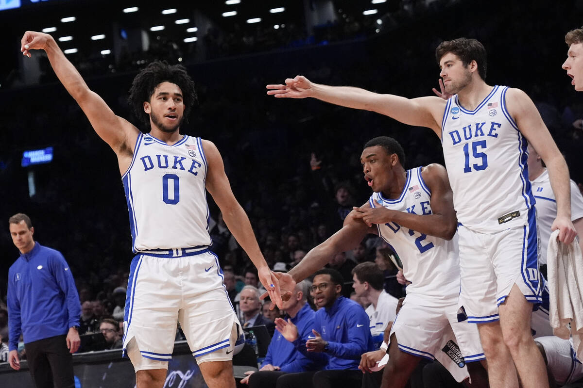 Duke guard Jared McCain (0) reacts after scoring a 3-point basket during the second half of a s ...