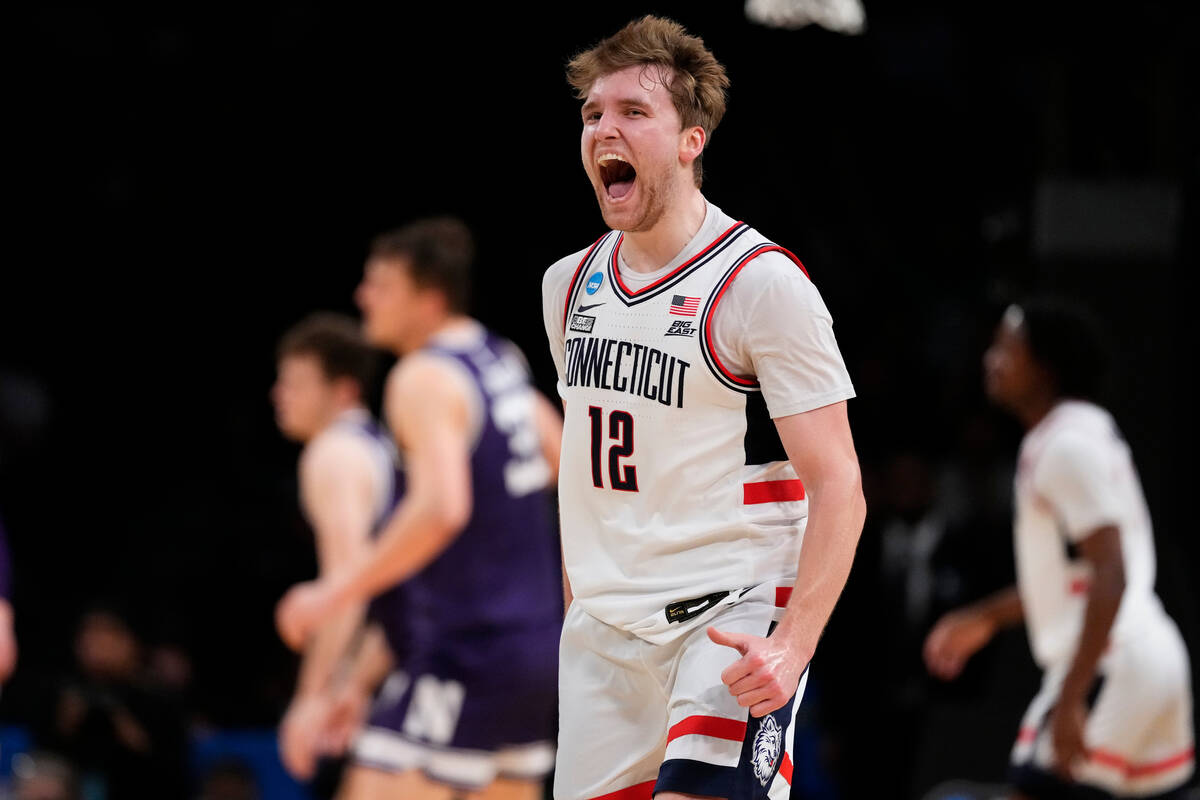 UConn's Cam Spencer (12) celebrates after making a 3-point shot during the first half of a seco ...