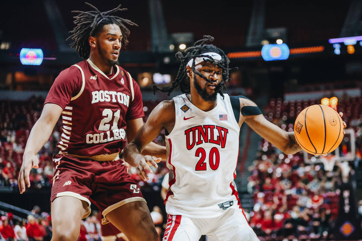 UNLV forward Keylan Boone (20) dribbles the ball as Boston College forward Devin McGlockton (21 ...