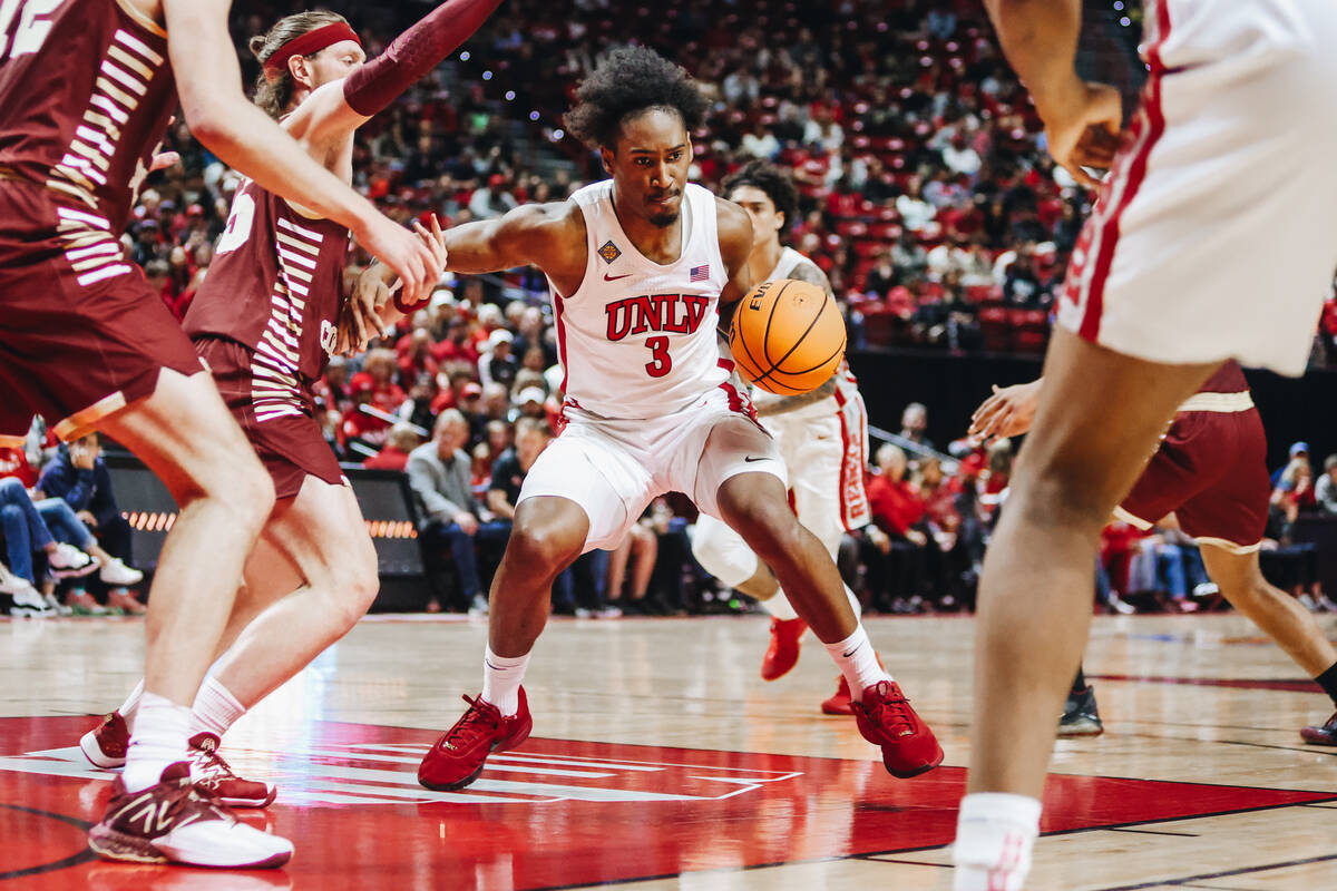 UNLV guard Shane Nowell (3) struggles to free himself from Boston College defense during a seco ...