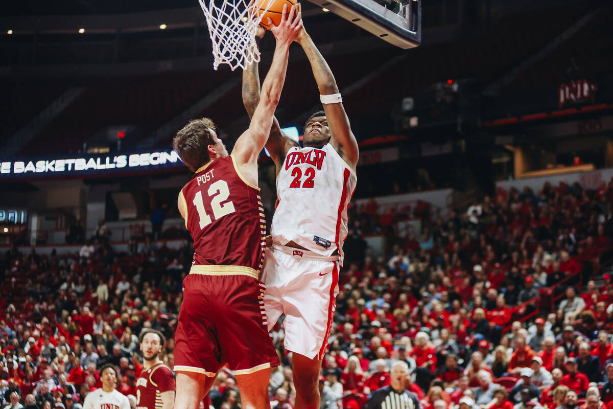 UNLV forward Karl Jones (22) goes up for a basket as Boston College forward Quinten Post (12) g ...