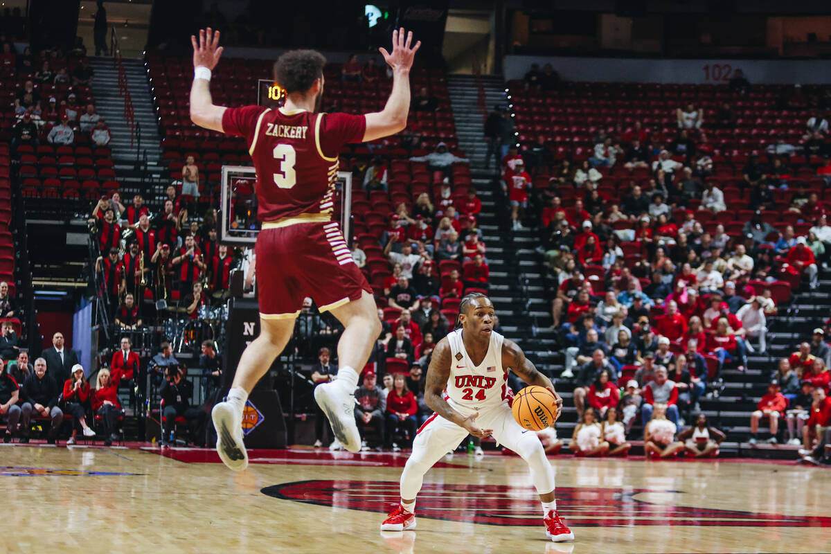 UNLV guard Jackie Johnson III (24) looks to pass the ball to a teammate as Boston College guard ...