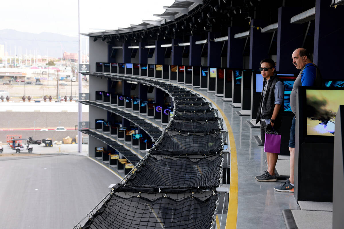 Gerald Wong, left, and Joseph Schlehner check out the fourth floor bays at Atomic Golf adjacent ...