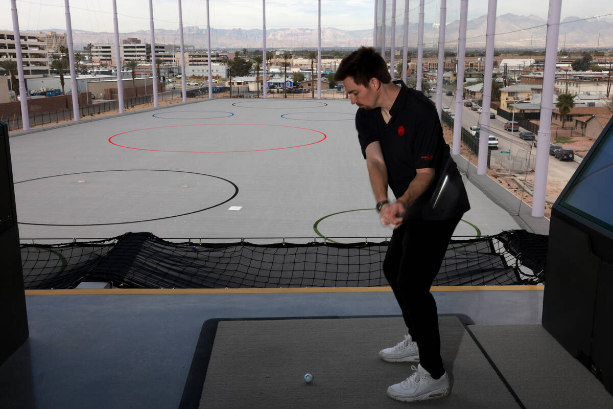 Alex Christiansen, creative director at Atomic Golf, hits from a fourth floor bay during the gr ...