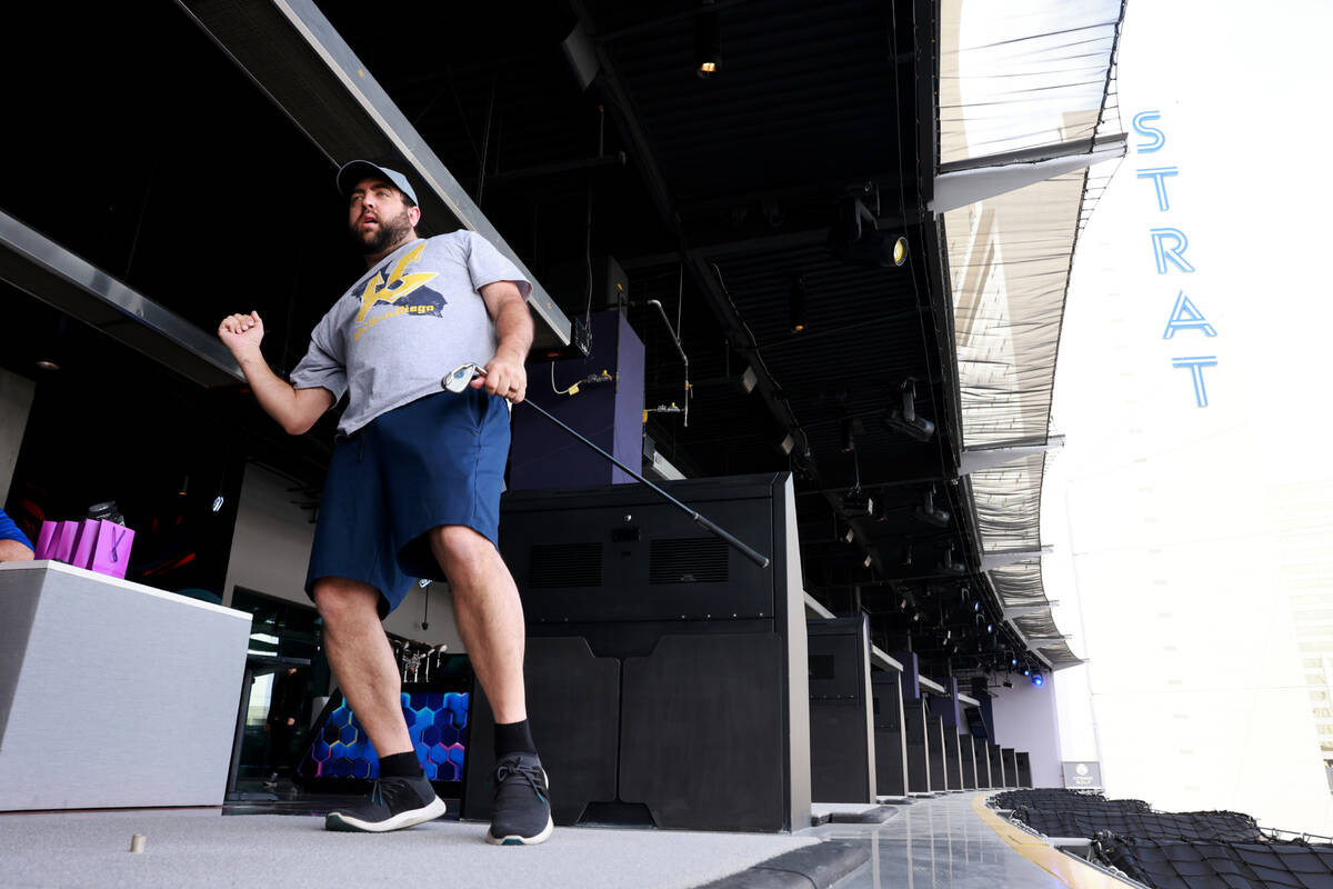 Anthony Schlehner watches the trajectory of his shot on the screen while hitting from a fourth ...