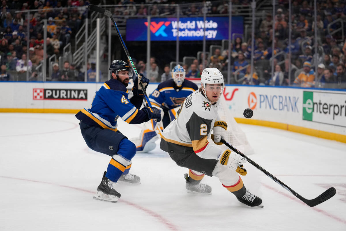 Vegas Golden Knights' Zach Whitecloud (2) reaches for a puck as St. Louis Blues goaltender Jord ...
