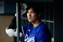 Los Angeles Dodgers designated hitter Shohei Ohtani (17) prepares his bat in the dugout during ...