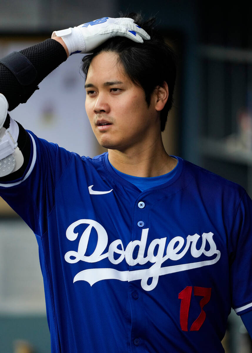 Los Angeles Dodgers designated hitter Shohei Ohtani walks through the dugout during the first i ...