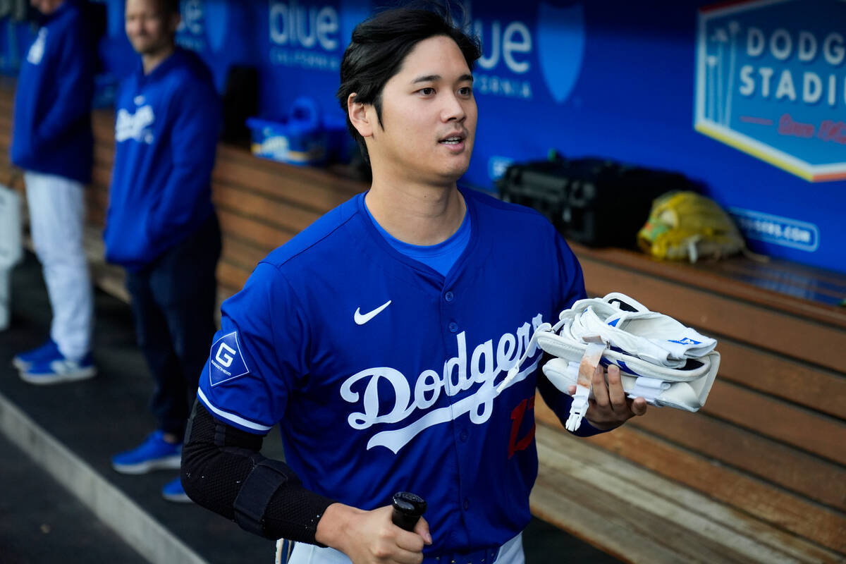 Los Angeles Dodgers designated hitter Shohei Ohtani runs through the dugout before a spring tra ...