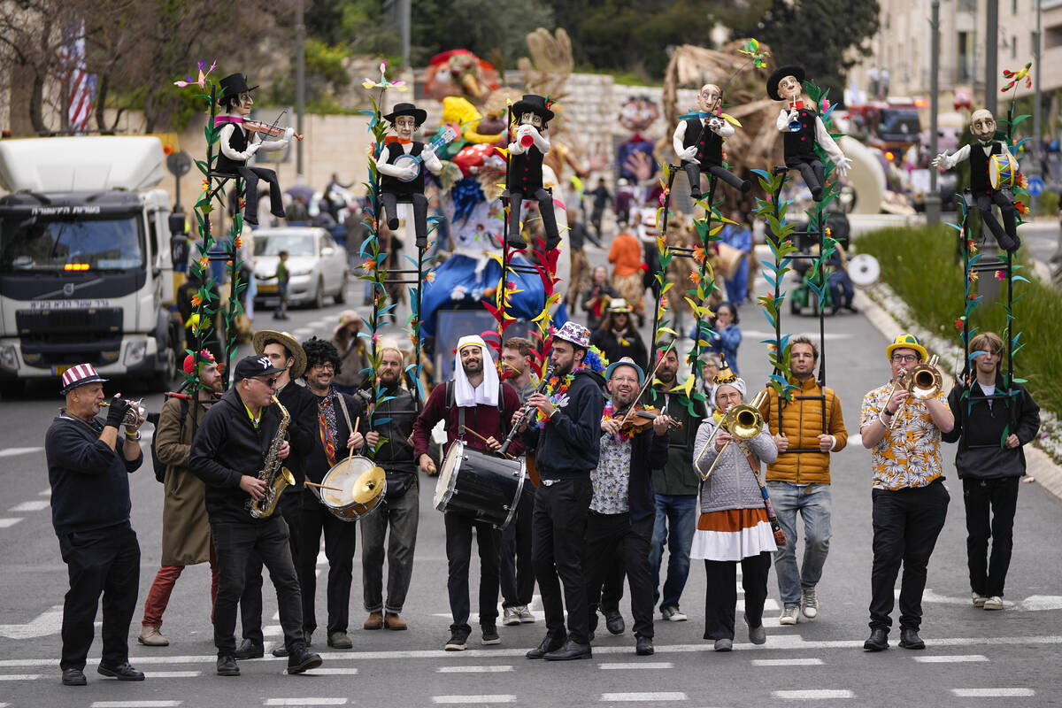 Performers play music during Purim parade in Jerusalem, Monday, March 25, 2024. (AP Photo/Ohad ...