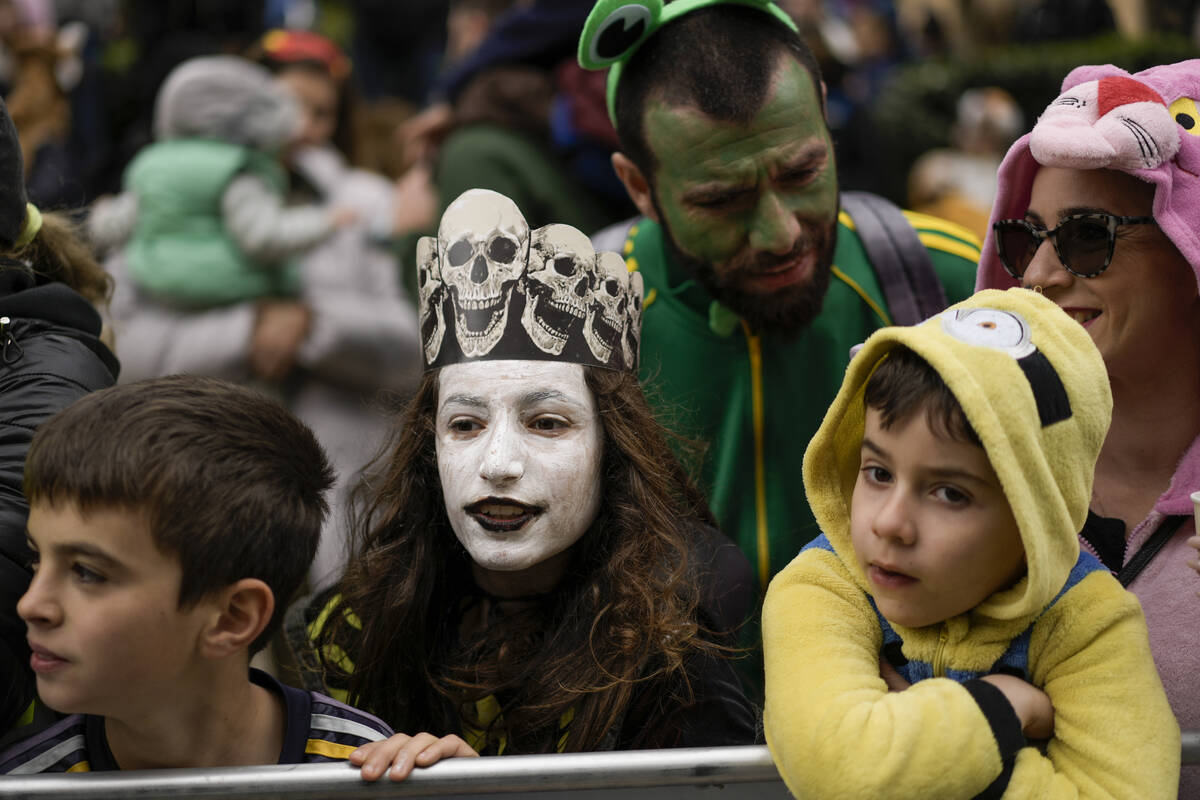 People watch the Purim parade in Jerusalem, Monday, March 25, 2024. (AP Photo/Leo Correa)