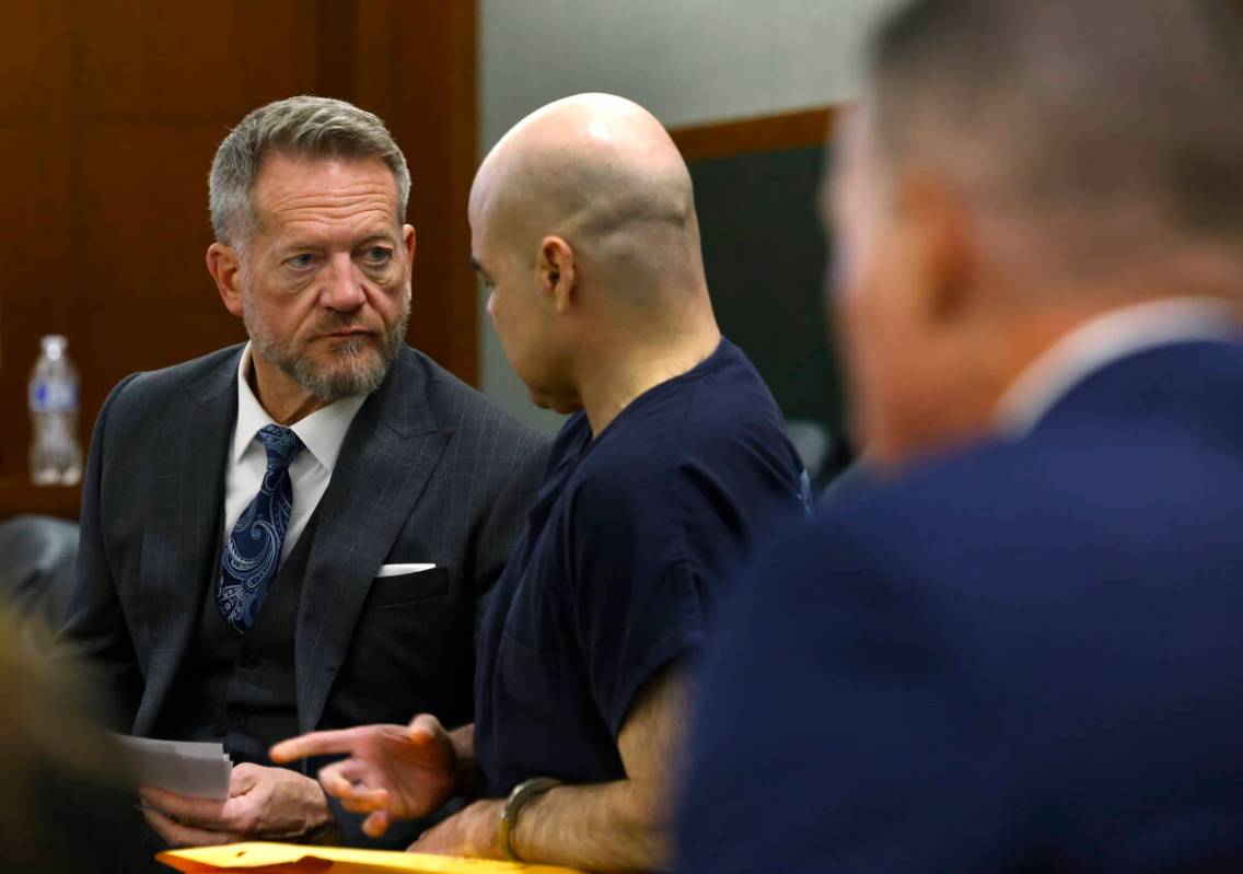 Attorney Robert Draskovich, left, listens to his client Robert Telles, a former Clark County Pu ...