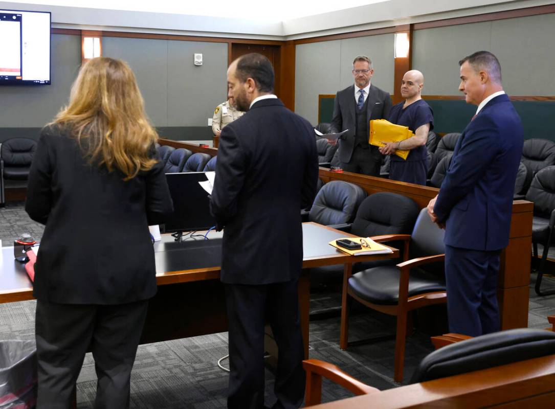 Pamela Weckerly, left, chief deputy district attorney, addresses the court as attorney Robert D ...