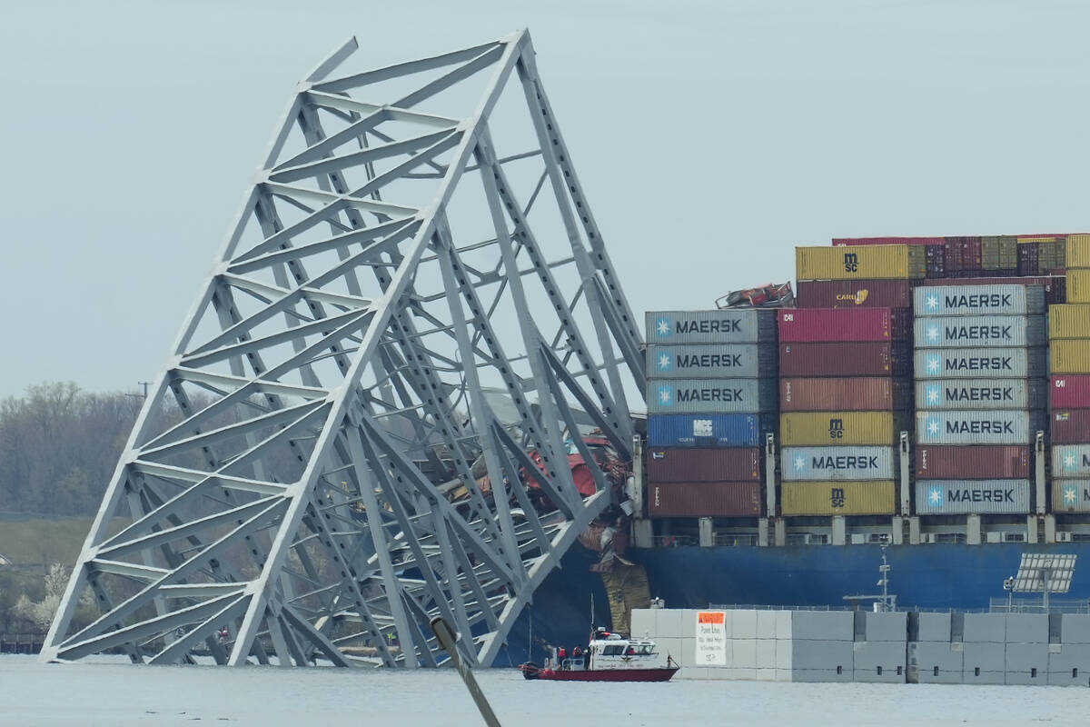 A container ship rests against wreckage of the Francis Scott Key Bridge on Tuesday, March 26, 2 ...