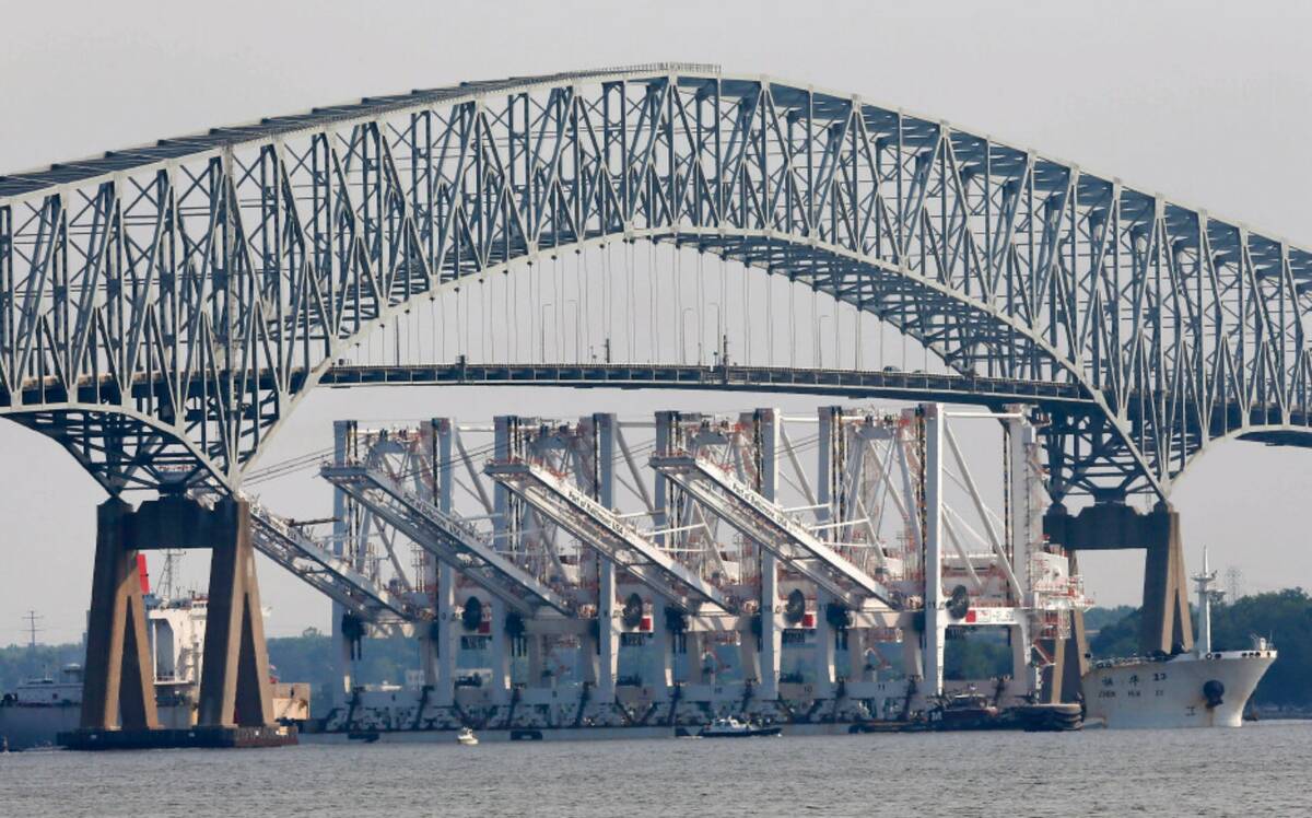 The vessel Zhen Hua 13 passes under the Francis Scott Key Bridge in Baltimore, Wednesday, June ...