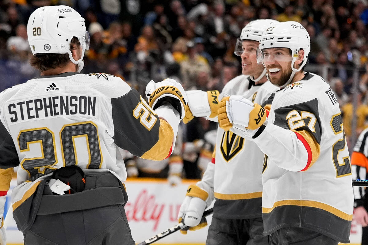 Vegas Golden Knights defenseman Shea Theodore (27) is congratulated by center Chandler Stephens ...