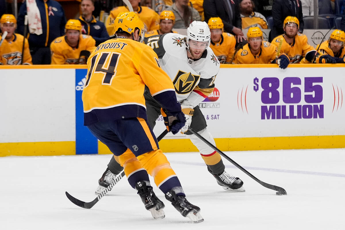 Vegas Golden Knights defenseman Noah Hanifin (15) passes the puck past Nashville Predators cent ...