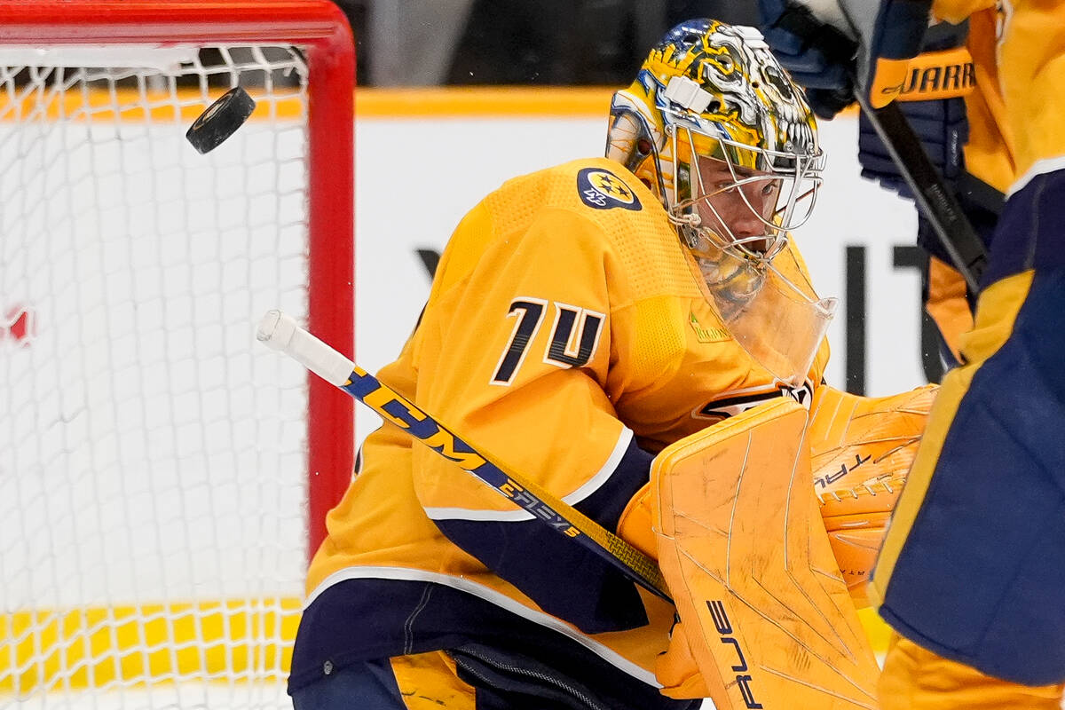 Nashville Predators goaltender Juuse Saros (74) deflects a shot on goal during the first period ...