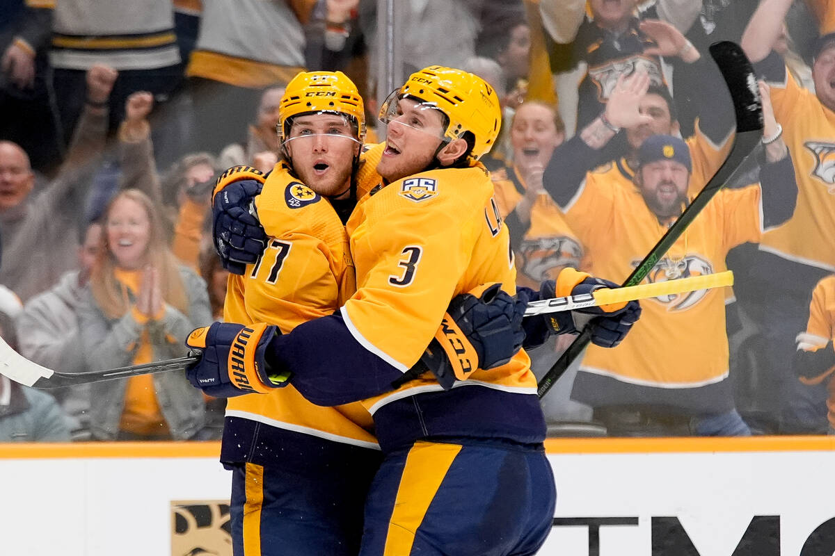 Nashville Predators center Mark Jankowski (17) celebrates his goal with defenseman Jeremy Lauzo ...