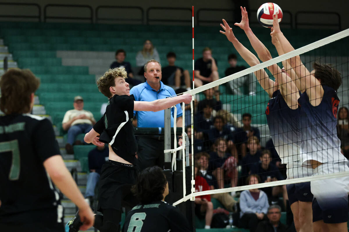 Palo Verde outside hitter Cole Manning hits past Coronado’s attempted block during a boy ...