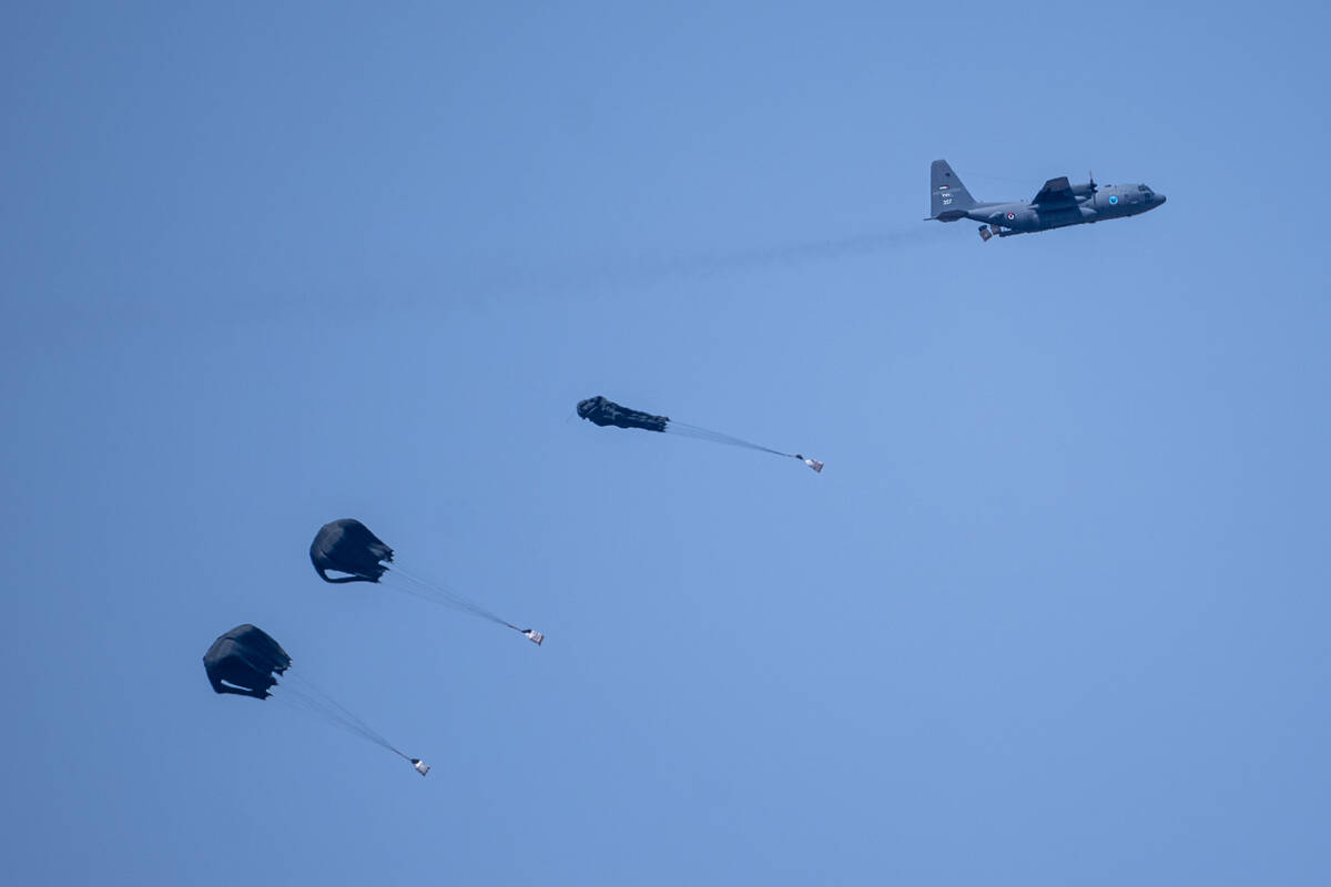 An aircraft airdrops humanitarian aid over the northern Gaza Strip, as seen from southern Israe ...