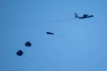 An aircraft airdrops humanitarian aid over the northern Gaza Strip, as seen from southern Israe ...