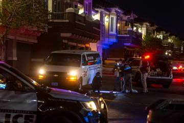 Metro officers examine a van as part of the scene of a homicide investigation in the Venicia Ap ...