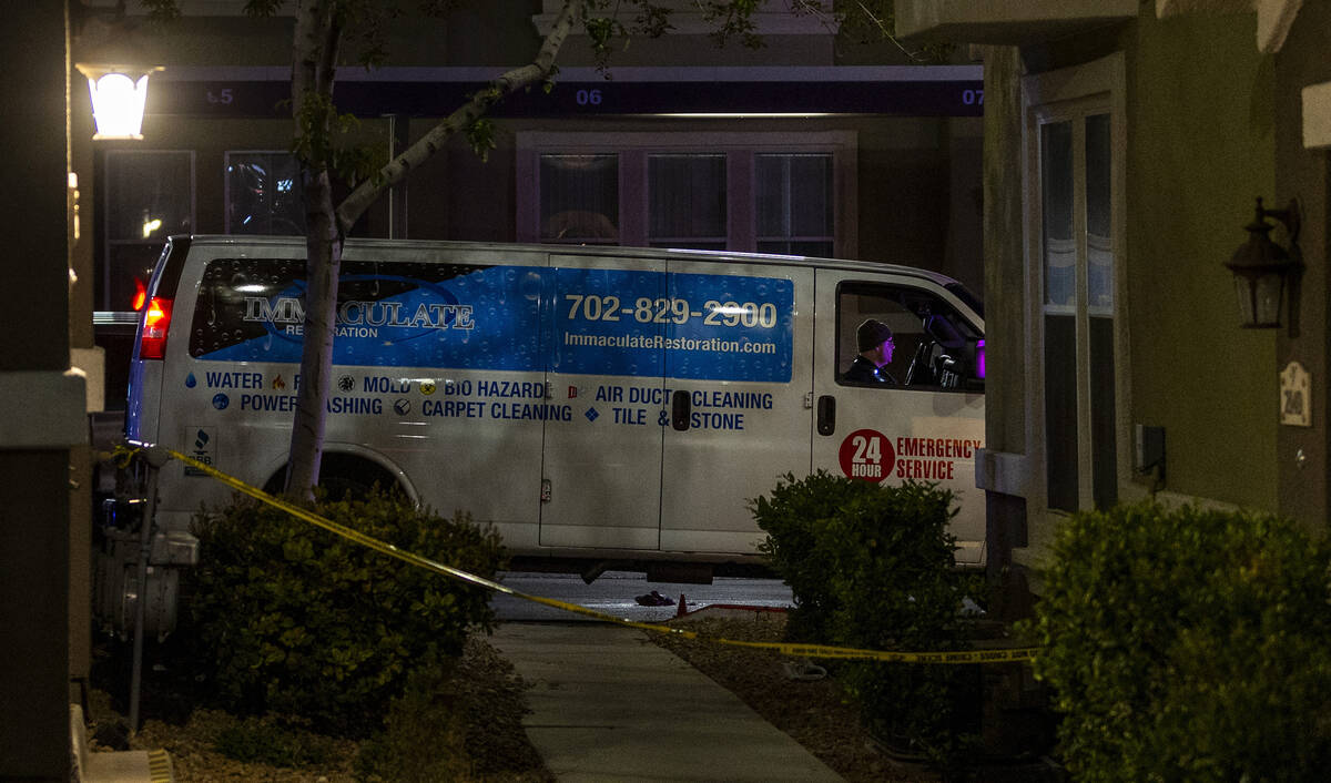 Metro officers examine a van as part of the scene of a homicide investigation in the Venicia Ap ...