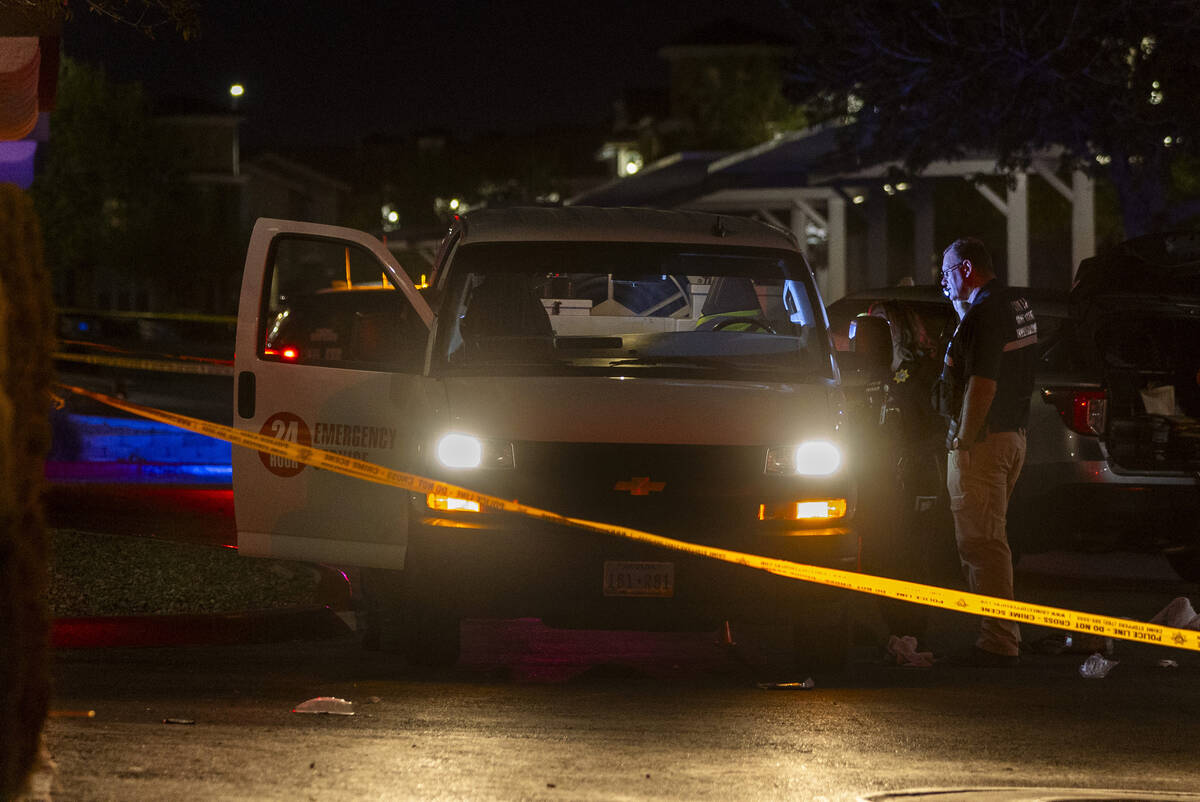 Metro officers examine a van as part of the scene of a homicide investigation in the Venicia Ap ...