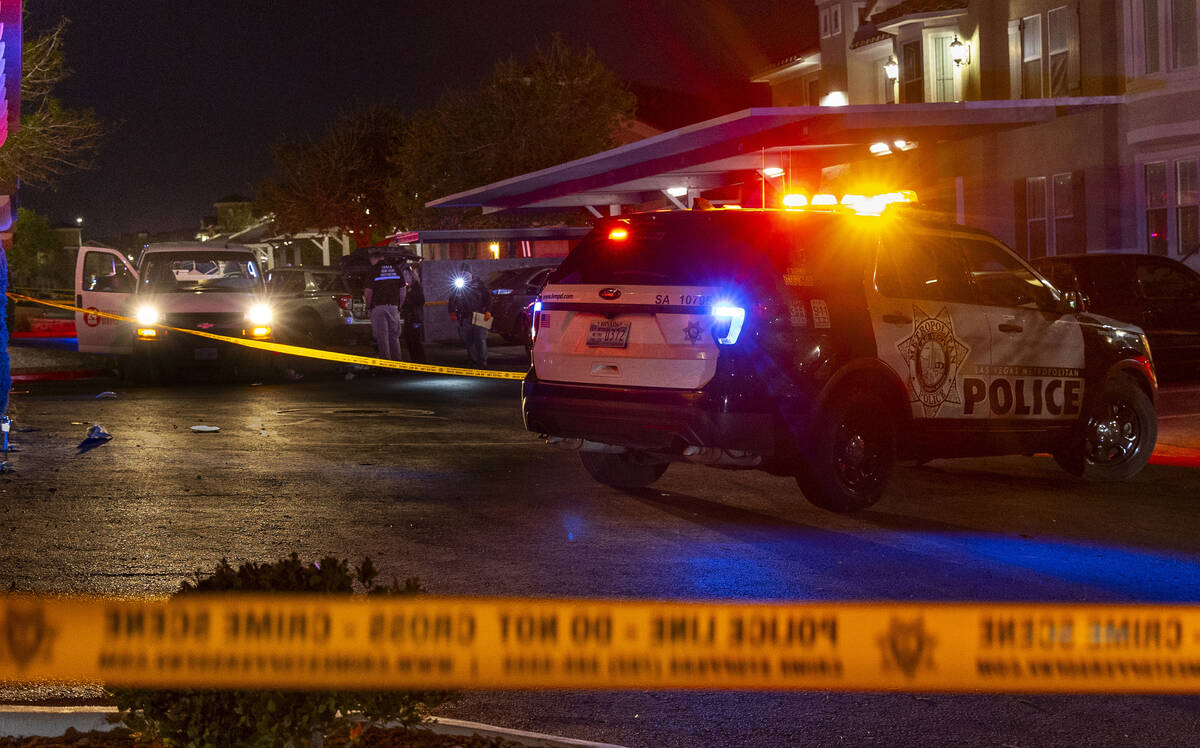 Metro officers examine a van as part of the scene of a homicide investigation in the Venicia Ap ...