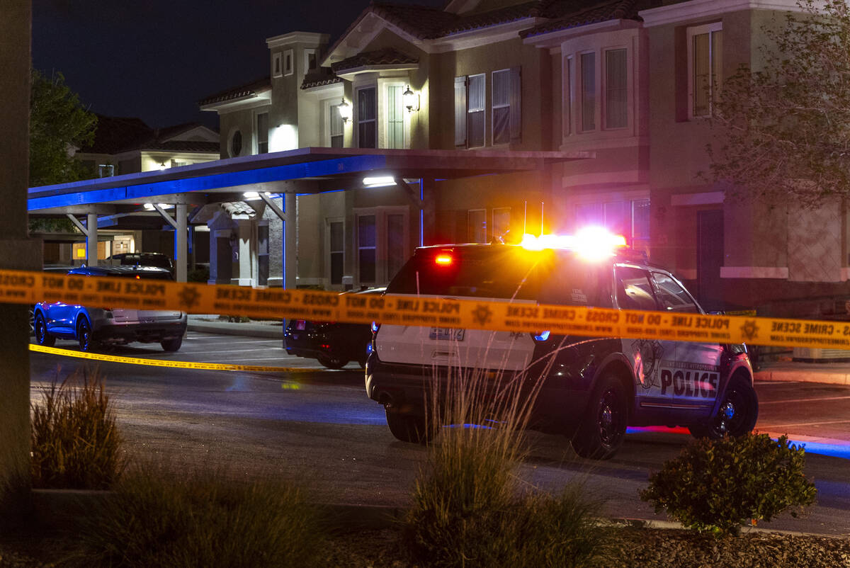 Metro officers examine a van as part of the scene of a homicide investigation in the Venicia Ap ...