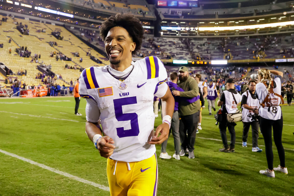 LSU quarterback Jayden Daniels (5) runs off the field following a win over Florida in an NCAA c ...