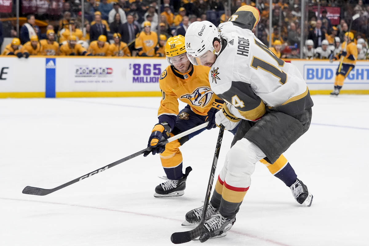 Vegas Golden Knights defenseman Nicolas Hague (14) skates the puck past Nashville Predators cen ...