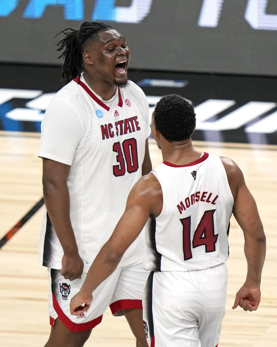 North Carolina State's DJ Burns Jr. (30) and Casey Morsell (14) celebrate a 79-73 overtime win ...
