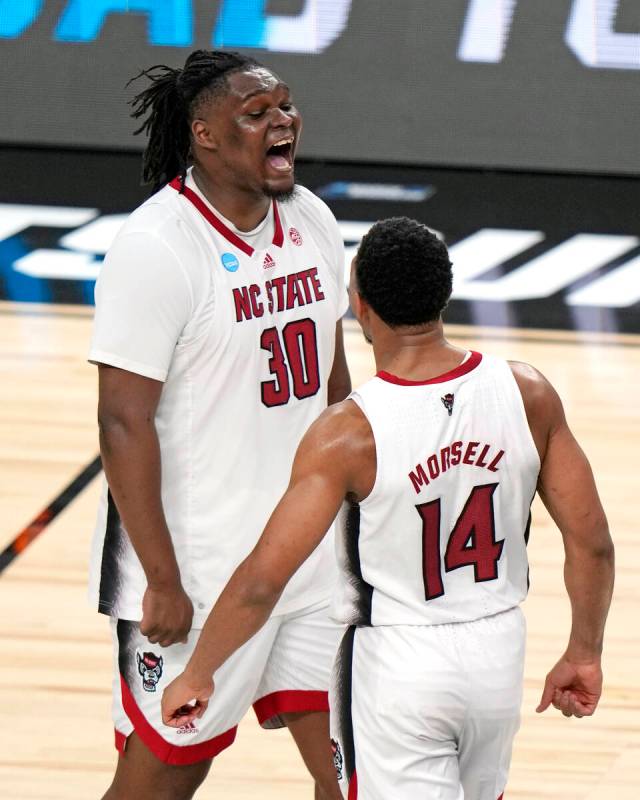 North Carolina State's DJ Burns Jr. (30) and Casey Morsell (14) celebrate a 79-73 overtime win ...