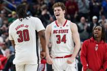 North Carolina State's DJ Burns, Jr. (30) and Ben Middlebrooks (34) celebrate after defeating O ...