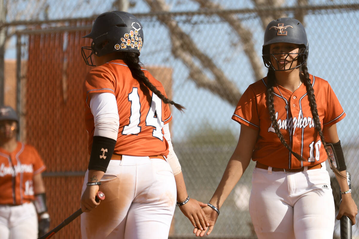 Legacy’s Aofia Noa (14) high fives infielder Fernanda Barrios (10) after scoring during ...