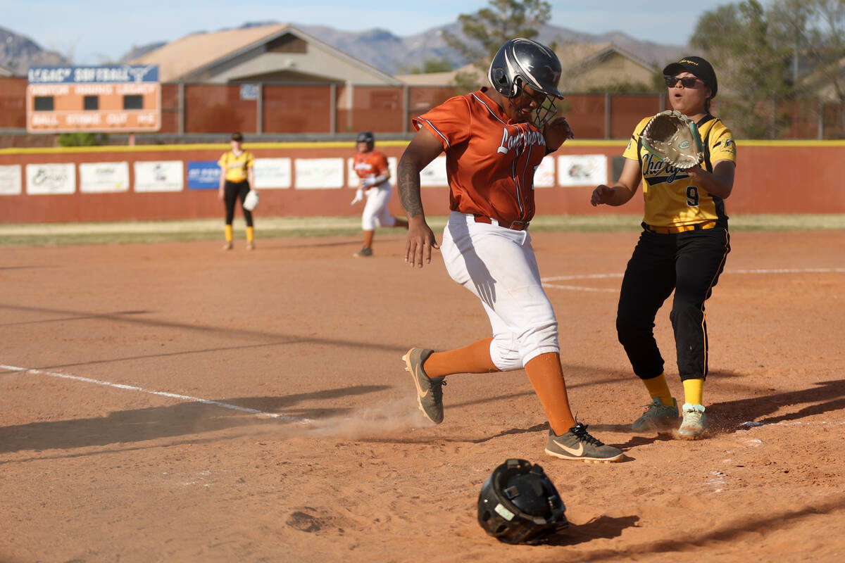 Legacy outfielder Anai Ware (12) makes it to home plate while Clark pitcher Kathy Solano (9) an ...