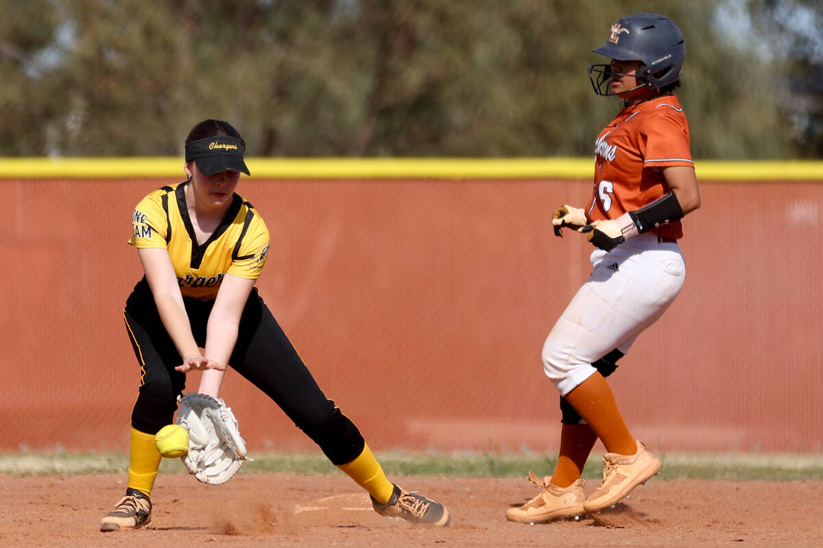 Clark's Lieba Gillet (2) reaches to catch while Legacy catcher Kristin Raudez (6) safely runs t ...