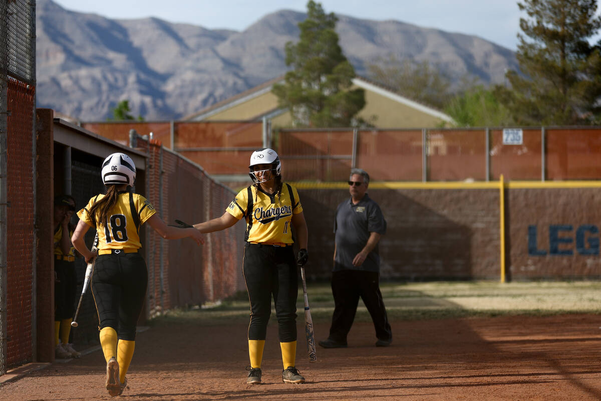 Clark’s Noel Gregorich (18) high fives Paola Garcia (11) after scoring during a high sch ...