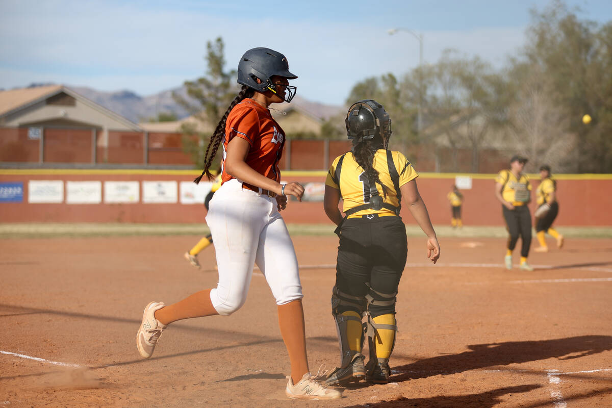 Legacy infielder Fernanda Barrios (10) scores as home plate while Clark catcher Sandra Peredes ...